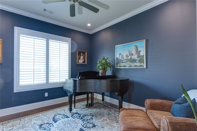 home office with hardwood / wood-style floors, ceiling fan, and ornamental molding