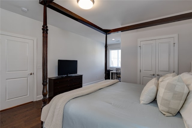 bedroom featuring a closet and dark wood-type flooring