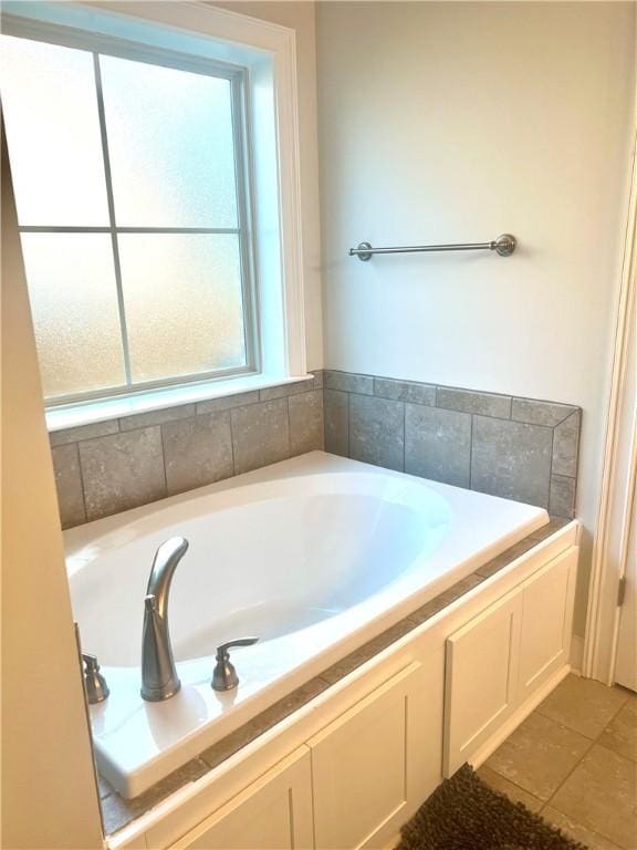 1836 Waterfall Rd, Auburn, AL 36830 - bathroom featuring a garden tub and tile patterned flooring