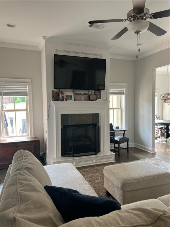 1836 Waterfall Rd, Auburn, AL 36830 - living room with plenty of natural light, ornamental molding, a ceiling fan, wood finished floors, and a tiled fireplace