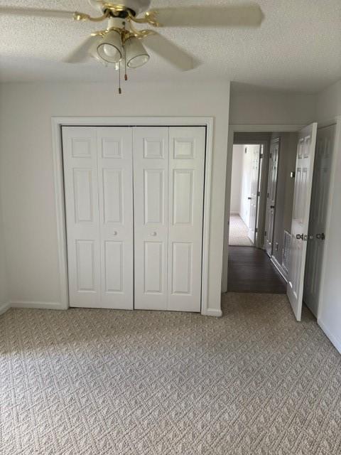 2420 38th Blvd, Valley, AL 36854 - unfurnished bedroom featuring light colored carpet, baseboards, a textured ceiling, a closet, and ceiling fan