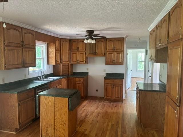 2420 38th Blvd, Valley, AL 36854 - kitchen with a sink, brown cabinets, a ceiling fan, wood finished floors, and a textured ceiling