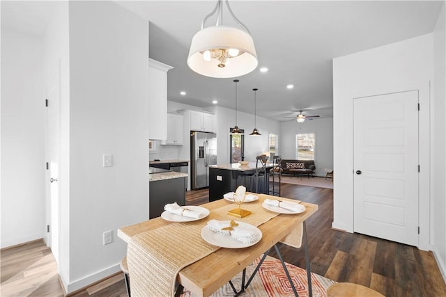 dining room featuring ceiling fan and dark hardwood / wood-style floors