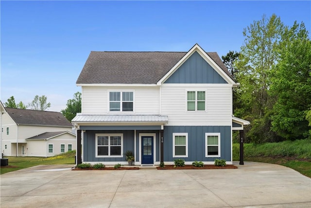 view of front of property with covered porch and central AC unit