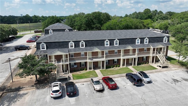 1761 Wire Rd Unit 409, Auburn, AL 36830 - view of building exterior with stairway and uncovered parking