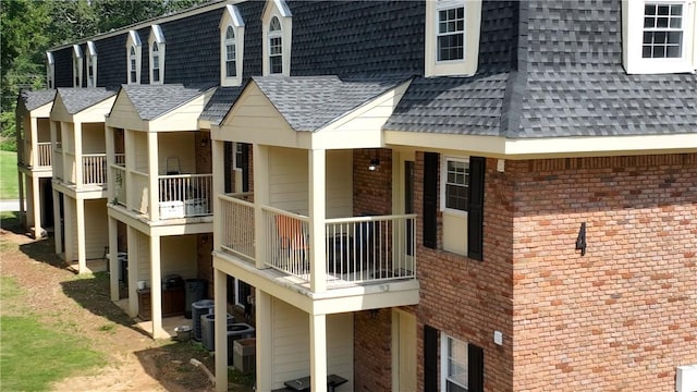 1761 Wire Rd Unit 409, Auburn, AL 36830 - view of home's exterior with a shingled roof, a balcony, and brick siding