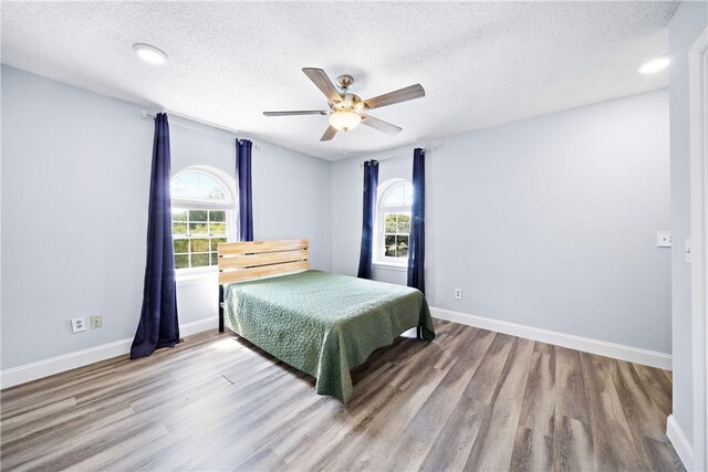 1761 Wire Rd Unit 409, Auburn, AL 36830 - bedroom with a textured ceiling, wood finished floors, and ceiling fan