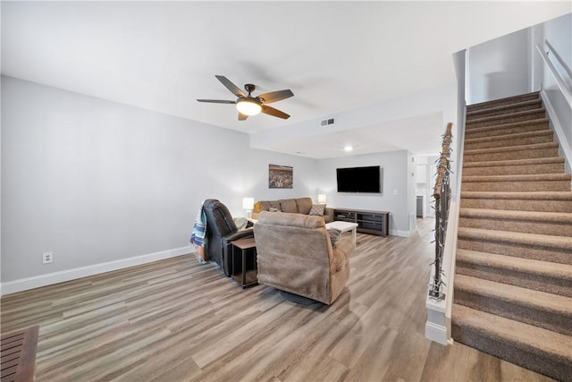 1761 Wire Rd Unit 409, Auburn, AL 36830 - living room featuring stairway, light wood finished floors, and a ceiling fan