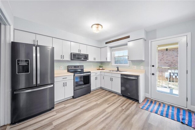 1761 Wire Rd Unit 409, Auburn, AL 36830 - kitchen with stainless steel appliances, light countertops, light wood-type flooring, and tasteful backsplash