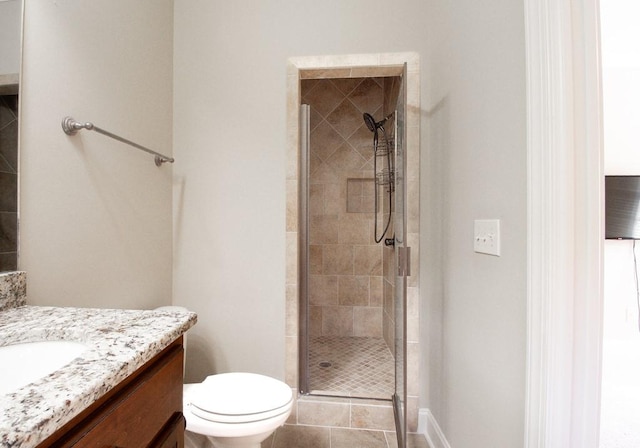 bathroom featuring walk in shower, vanity, toilet, and tile patterned flooring