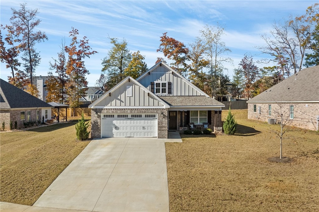 view of front of property with a garage, a front lawn, and cooling unit