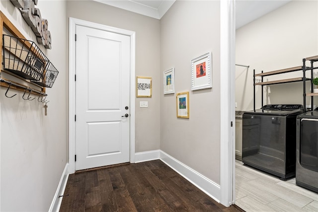 doorway to outside featuring baseboards, independent washer and dryer, and wood finished floors