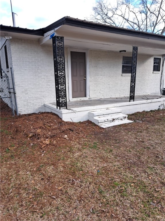 view of exterior entry with a porch