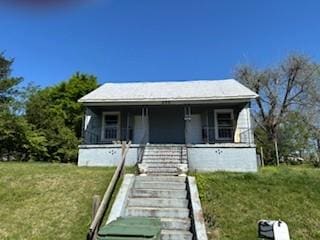 bungalow with stairway, a porch, and a front lawn