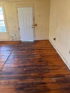 empty room with baseboards and wood finished floors