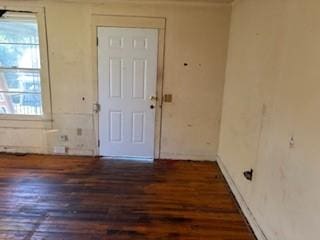 foyer with baseboards and wood finished floors