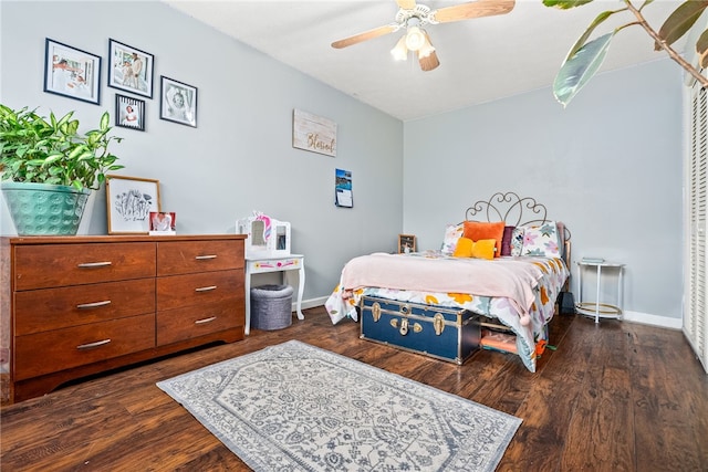 bedroom with dark hardwood / wood-style flooring and ceiling fan