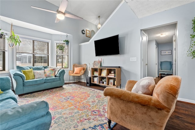 living room featuring vaulted ceiling, ceiling fan, a textured ceiling, and dark hardwood / wood-style flooring