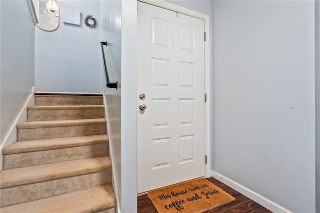 staircase with wood-type flooring