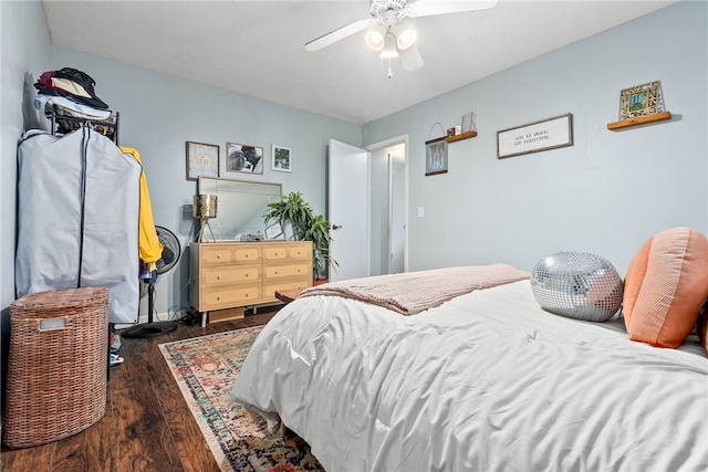 bedroom with dark hardwood / wood-style flooring and ceiling fan