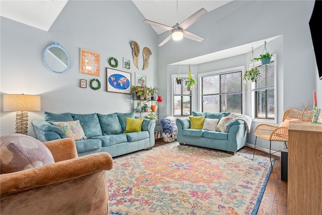 living room featuring hardwood / wood-style flooring, ceiling fan, and high vaulted ceiling