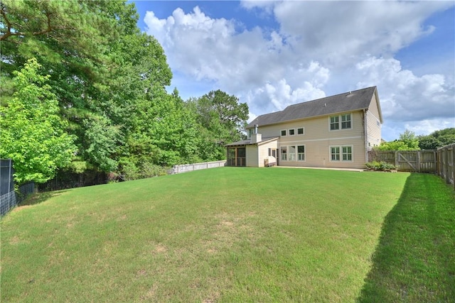 227 Westover St, Auburn, AL 36832 - rear view of house with a fenced backyard and a sunroom