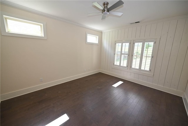 227 Westover St, Auburn, AL 36832 - unfurnished room featuring crown molding, dark wood-type flooring, ceiling fan, and wood walls