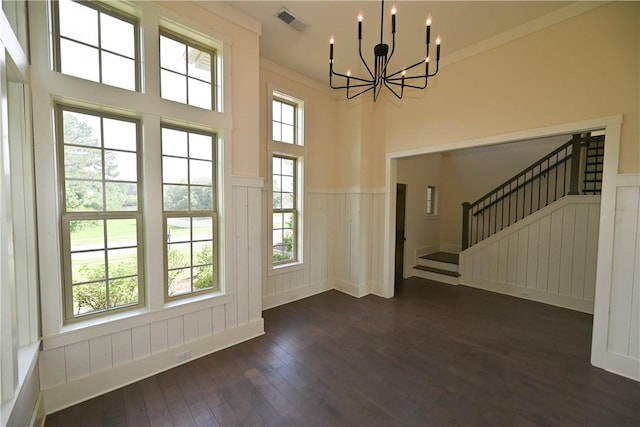 227 Westover St, Auburn, AL 36832 - unfurnished dining area featuring a wainscoted wall, a chandelier, dark wood finished floors, stairs, and a decorative wall