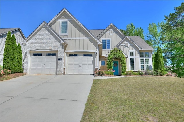 227 Westover St, Auburn, AL 36832 - view of front of house featuring board and batten siding, driveway, stone siding, a garage, and a front yard