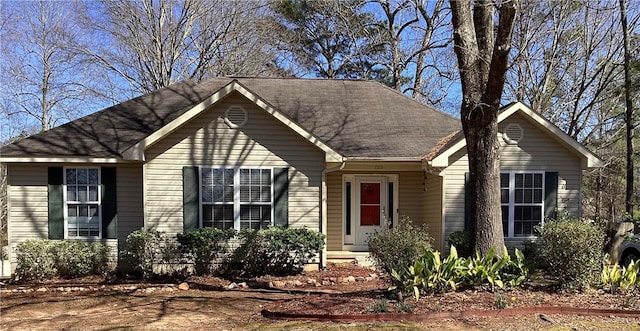 ranch-style home featuring roof with shingles