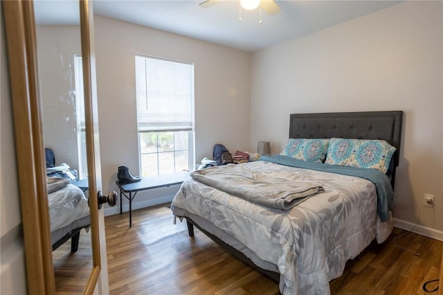 bedroom with baseboards, ceiling fan, and wood finished floors