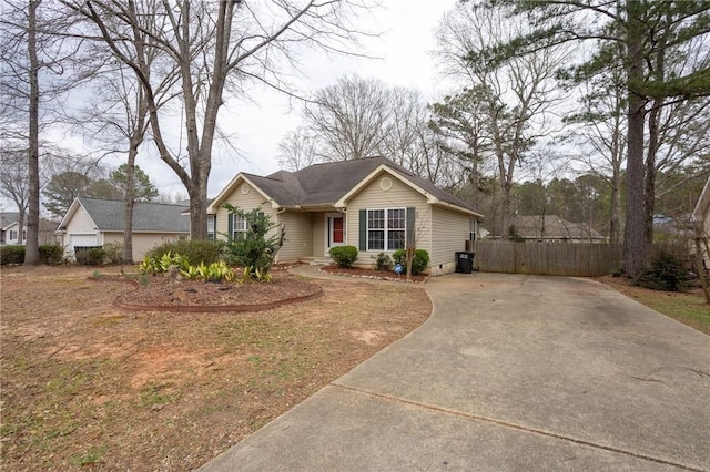 ranch-style home with driveway and fence