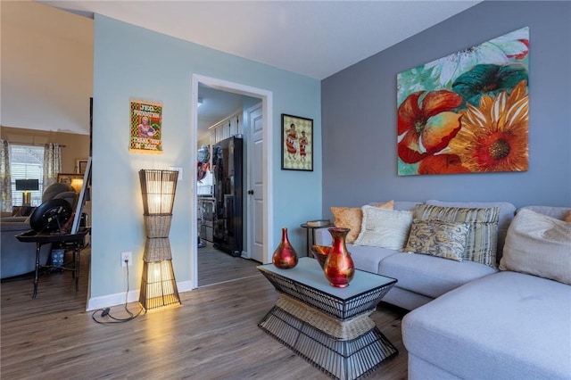 living room with baseboards and wood finished floors