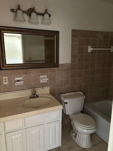 bathroom featuring tile patterned flooring, vanity, toilet, and tile walls