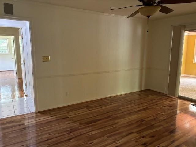 empty room featuring dark hardwood / wood-style flooring and ceiling fan