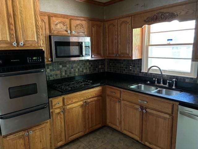 kitchen featuring tile patterned flooring, sink, backsplash, and black appliances