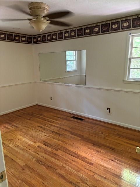 spare room featuring ceiling fan and hardwood / wood-style floors