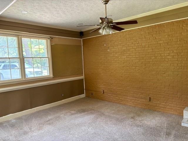 unfurnished room with carpet flooring, ceiling fan, crown molding, and a textured ceiling