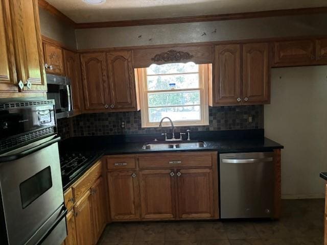 kitchen featuring appliances with stainless steel finishes, tasteful backsplash, and sink