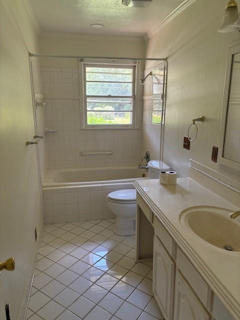 full bathroom featuring toilet, tile patterned flooring, vanity, and tiled shower / bath