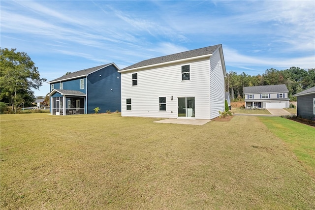 rear view of house featuring a yard, a patio area, and a sunroom