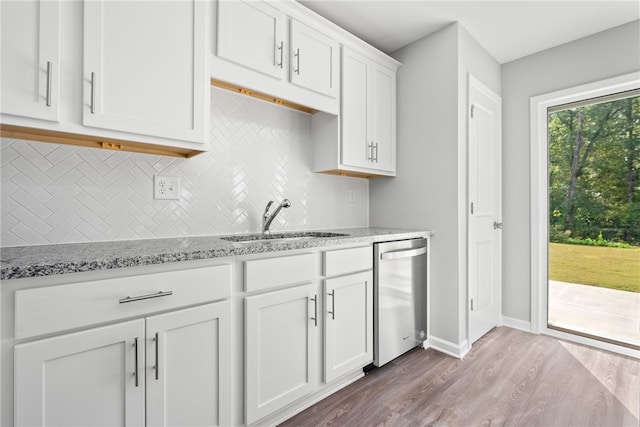 kitchen with dishwasher, sink, light hardwood / wood-style flooring, light stone counters, and white cabinetry