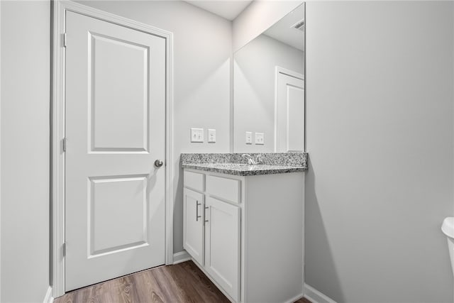 bathroom with vanity and hardwood / wood-style flooring