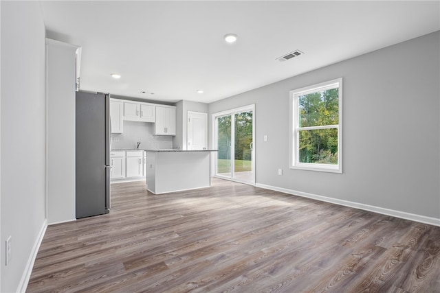 unfurnished living room featuring hardwood / wood-style flooring