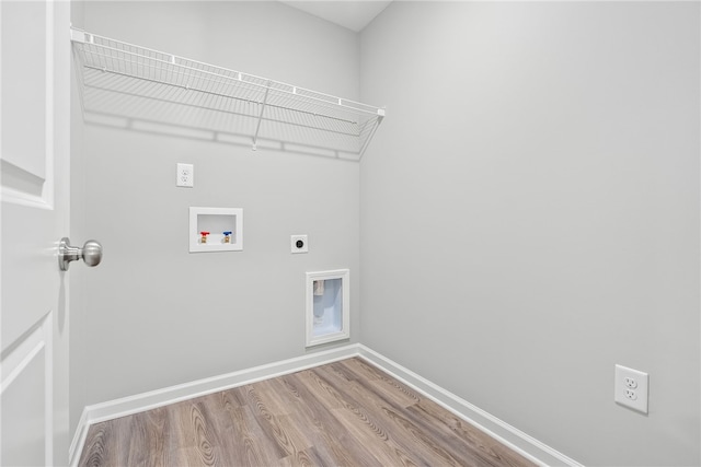 washroom with hookup for an electric dryer, hardwood / wood-style floors, and washer hookup