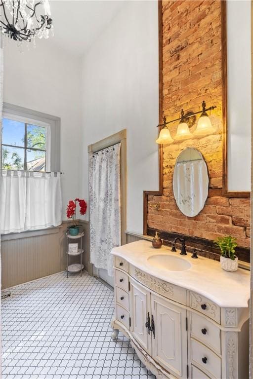 1008 3rd Ave, Opelika, AL 36801 - full bathroom with vanity, wainscoting, a chandelier, wood walls, and a towering ceiling