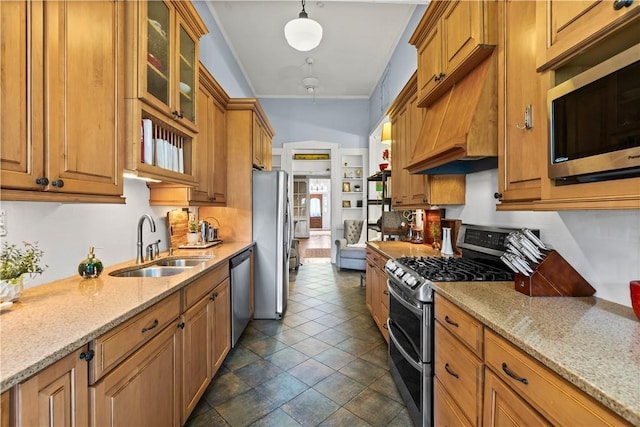 1008 3rd Ave, Opelika, AL 36801 - kitchen with appliances with stainless steel finishes, custom exhaust hood, brown cabinetry, light stone countertops, and glass insert cabinets