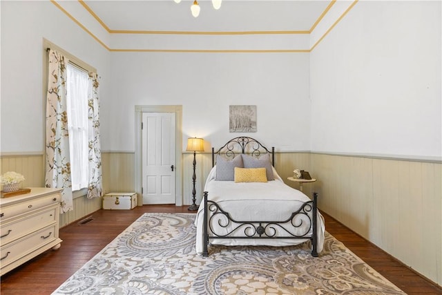 1008 3rd Ave, Opelika, AL 36801 - bedroom featuring wainscoting, dark wood-style flooring, and ornamental molding
