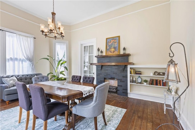 1008 3rd Ave, Opelika, AL 36801 - dining space featuring a chandelier, wood-type flooring, ornamental molding, and a fireplace
