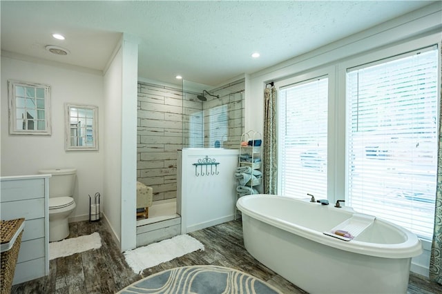 1249 County Road 446, Five Points, AL 36855 - full bath featuring wood finished floors, a walk in shower, vanity, a freestanding bath, and a textured ceiling